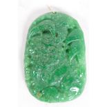 A Chinese carved green hardstone pendant, 2½" long