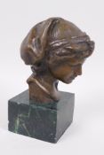 A bronze bust after the antique, mounted on a marbled socle, 5" high