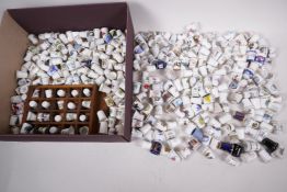 A quantity of ceramic collectors thimbles, numerous designs, approximately 200