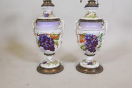 A pair of C19th porcelain and gilt metal mounted lamps, with hand painted grape and vine decoration,
