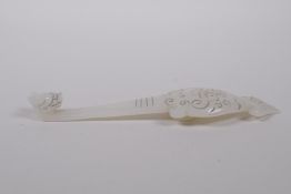 A Chinese white jade belt hook with carved stylised dragon decoration, 6" long
