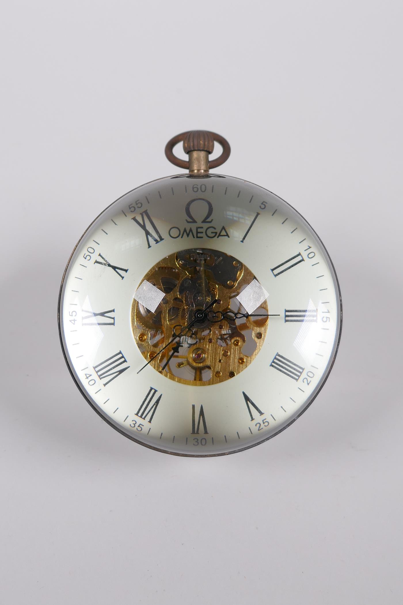 A glass ball desk clock with brass mounts, 3" diameter