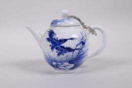 A Chinese blue and white porcelain teapot decorated with two Asiatic birds and a lotus lily pad,