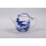 A Chinese blue and white porcelain teapot decorated with two Asiatic birds and a lotus lily pad,