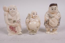 Three carved bone netsuke, a seated man with a large tablet, a man with chest of drawers and a