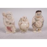 Three carved bone netsuke, a seated man with a large tablet, a man with chest of drawers and a