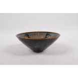 A Cizhou kiln conical bowl with butterfly decoration, Chinese origin, 6½" diameter