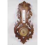 A French carved walnut cased aneroid barometer and thermometer, 19" long