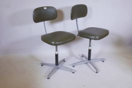 A pair of mid C20th industrial 'Omal Group' office chairs in olive green leatherette