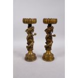 A pair of Chinese bronze pricket candlesticks, with coiled dragons around the stems, 4 character
