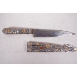 A steel gaucho knife with elaborately decorated gilt embellished handle and scabbard, bears small