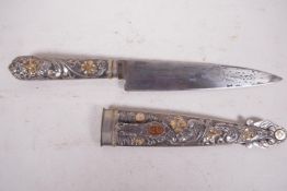 A steel gaucho knife with elaborately decorated gilt embellished handle and scabbard, bears small