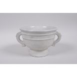 A Chinese Song style cream coloured crackle glazed pottery cup with two handles, 9 character mark to