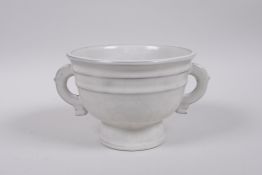 A Chinese Song style cream coloured crackle glazed pottery cup with two handles, 9 character mark to