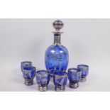 A silver overlaid blue glass liqueur set of eight decanters and six glasses decorated with leaves