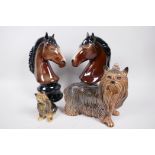 Two Beswick style porcelain figurines of horse heads 10" high, together with two figures of