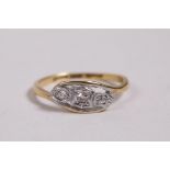An 18ct yellow gold and platinum three stone diamond ring, approximate size 'N'