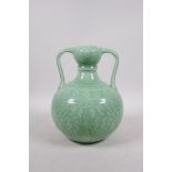 A Chinese green glazed porcelain garlic head shaped vase with two handles and underglaze lotus