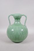 A Chinese green glazed porcelain garlic head shaped vase with two handles and underglaze lotus