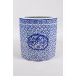 A Chinese Republic blue and white porcelain brush pot with decorative floral panels, 7" high x 7"