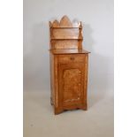 A C19th Continental elm cabinet, inset with pollard veneers, the Gothic style back with open shelves