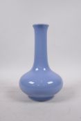 A Chinese light blue glazed porcelain bottle vase, of squat form, 6 character mark to base, 8½" high