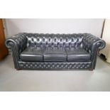 A black leather three seater Chesterfield, 78" wide
