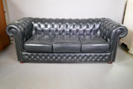 A black leather three seater Chesterfield, 78" wide