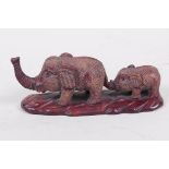 A Japanese carved wood okimono figure of two elephants (signed), 4½" long