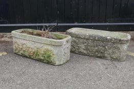 A pair of reconstituted stone planters with iron mask decoration, 28" x 11" x 10"