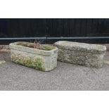 A pair of reconstituted stone planters with iron mask decoration, 28" x 11" x 10"