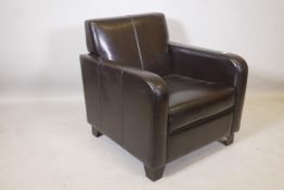 A dark brown leather club armchair on block feet, 30½" high, 29" wide