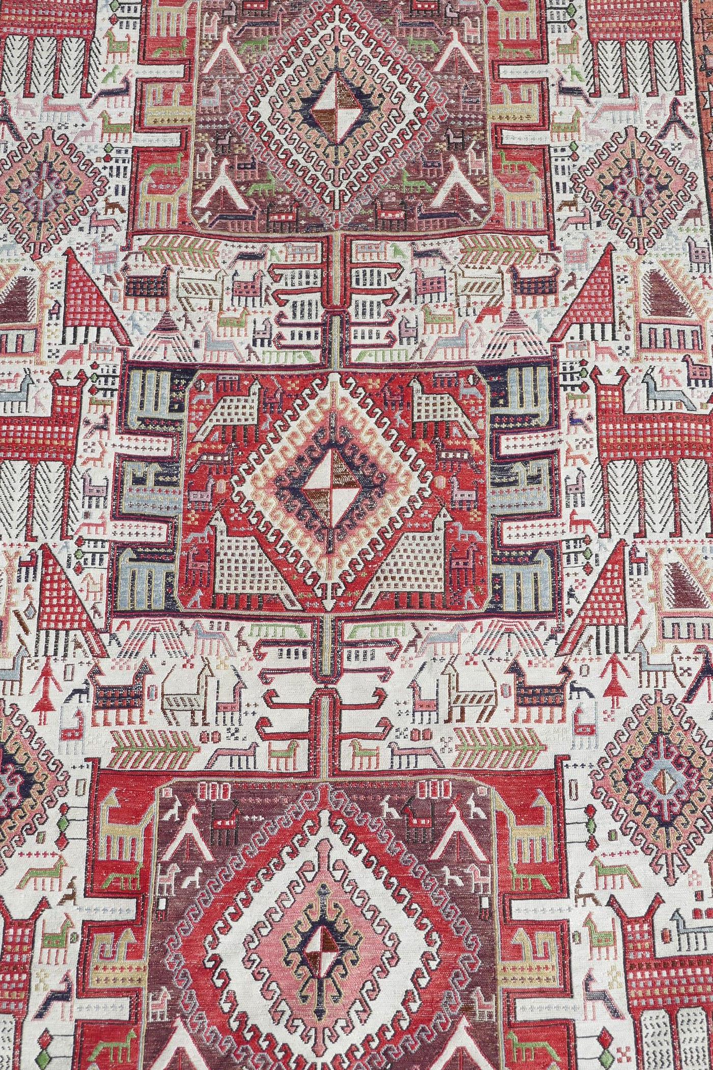 A Persian multicolour ground silk and wool rug decorated with three medallions and geometric