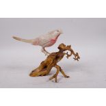 A Japanese bone okimono, carved in the form of an asiatic bird perched on a stump, 5½" high