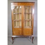 An Edwardian inlaid mahogany display cabinet with astragal glazed doors, raised on cabriole