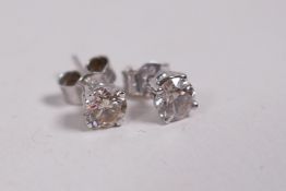 A pair of 14ct white gold diamond stud earrings, approximately 62 points