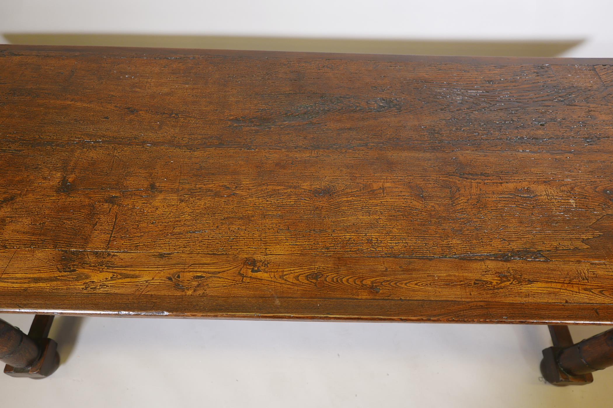 An antique oak refectory table, with plank top and carved frieze raised on gun barrel turned - Image 3 of 9