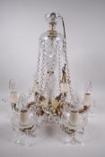 A brass and cut crystal glass chandelier, with six lights, 19" high, 18" diameter