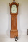 An early C19th oak long case clock, the arched dial painted with a balloon, highlighted in raised