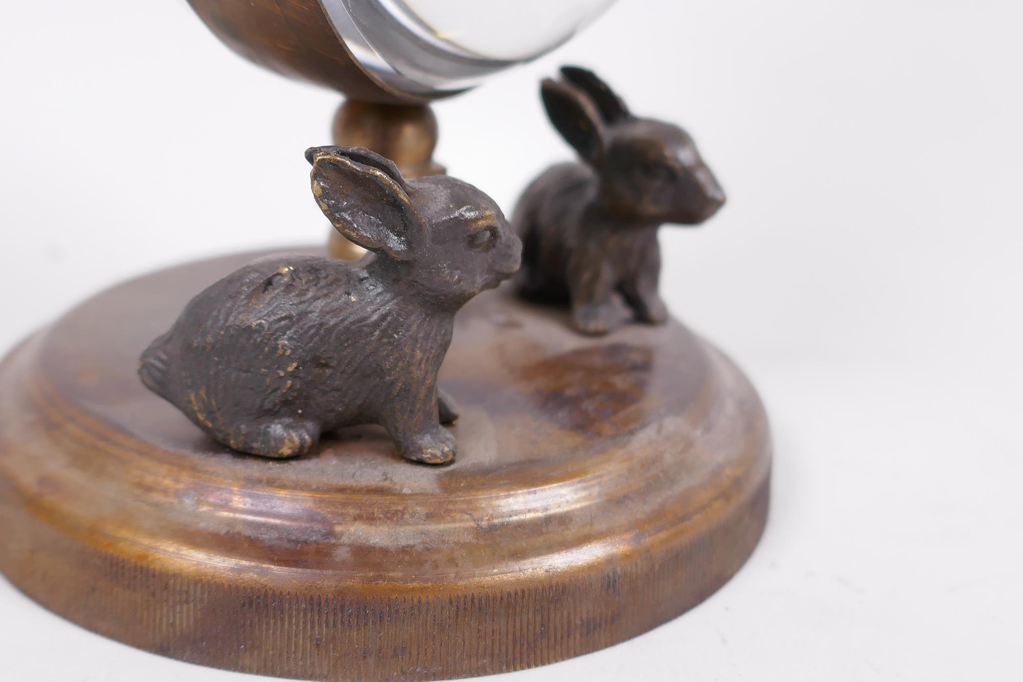 An unusual desk top ball clock, the base with two cast figures of rabbits, the clock surmounted with - Image 3 of 5