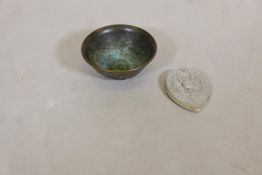 A bronze finger bowl with raised elephant decoration, 2" diameter, and a white metal Buddha pendant