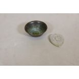 A bronze finger bowl with raised elephant decoration, 2" diameter, and a white metal Buddha pendant