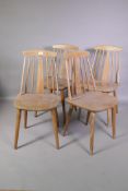 A set of four mid C20th continental stick back kitchen chairs