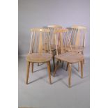 A set of four mid C20th continental stick back kitchen chairs