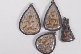 Four Tibetan Buddhist pendants, largest 3" long