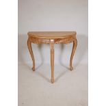 A pine demi lune console table, with carved frieze, raised on cabriole supports, 32" x 16" x 30"