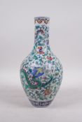 A Chinese doucai porcelain bottle vase decorated with dragons amongst flowers, seal mark to base,