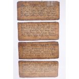 A framed set of four Tibetan manuscripts, 11" x 5"
