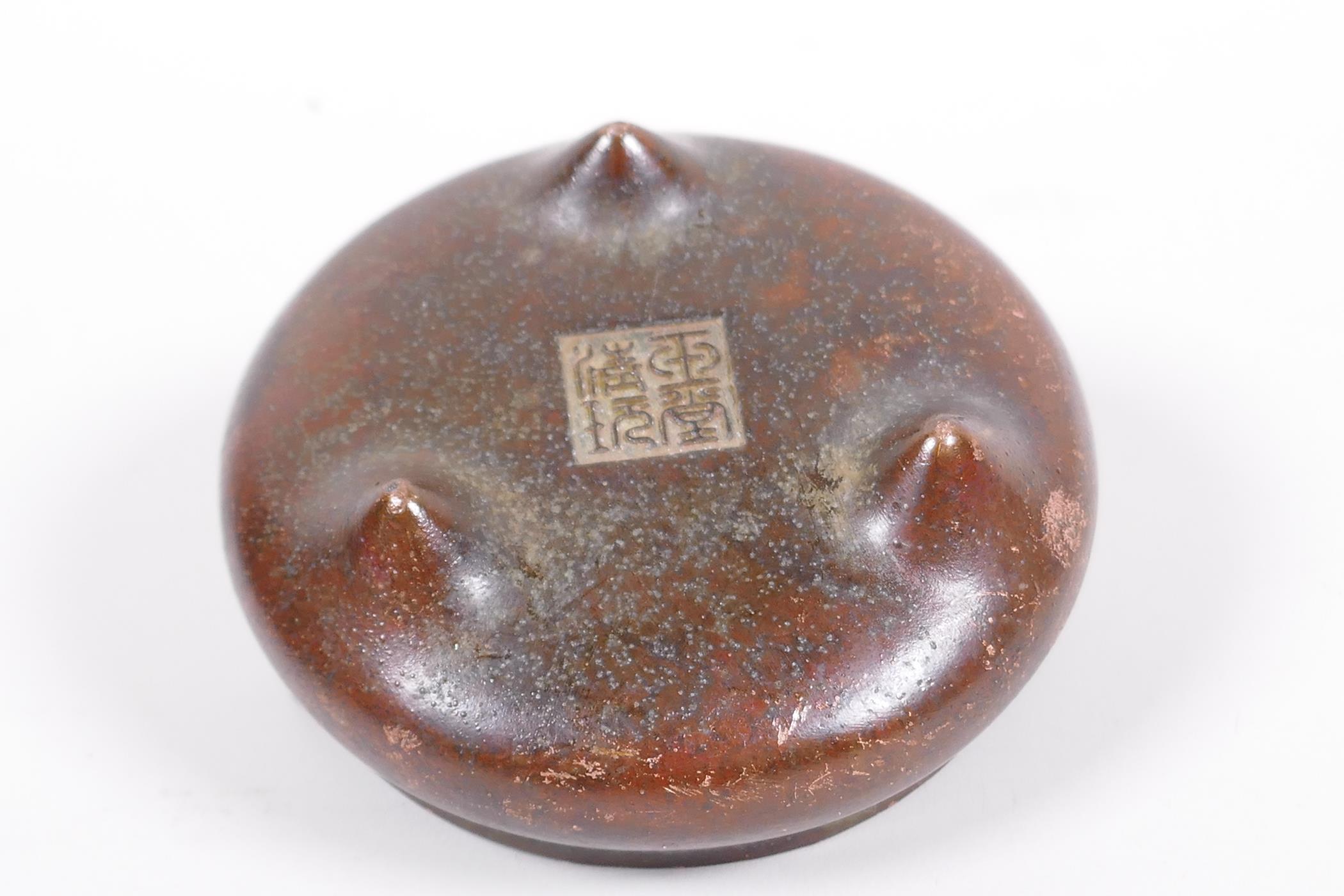 A small Chinese bronze censer with phoenix eye handles and three cast supports, impressed seal - Image 3 of 4