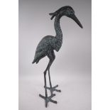 A patinated metal garden figure of a heron, 27" high